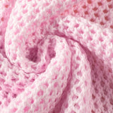 Close-up of pink crochet fabric showing detailed texture of floral mesh beach sweater by Trendsi