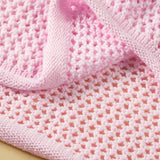 Pink crochet floral mesh beach sweater showing detailed knit pattern and texture