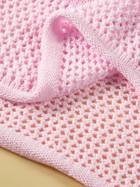 Pink crochet floral mesh beach sweater showing detailed knit pattern and texture