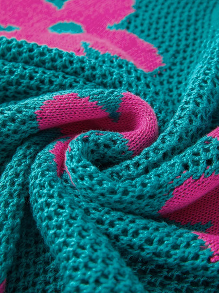 Close-up of teal crochet top with pink floral pattern showing floral mesh beach sweater texture