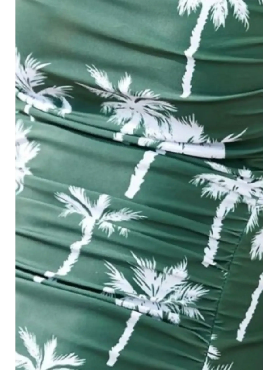 Beach Babes floral one piece swimsuit with green fabric and white palm tree print close-up