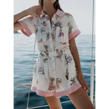 Trendsi floral resort romper for women with short sleeves and belted waist near ocean
