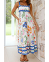 woman wearing floral resort wear dress with colorful floral patterns and blue trim maxi dress