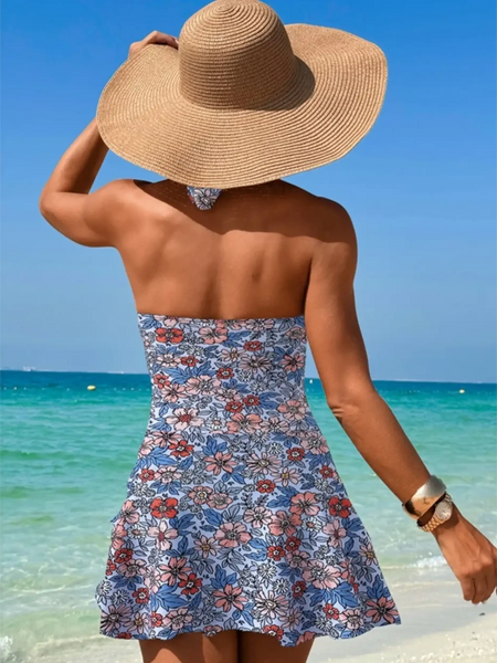 Beach Babes sexy cutout swim dress with floral pattern worn at the beach by woman with sunhat