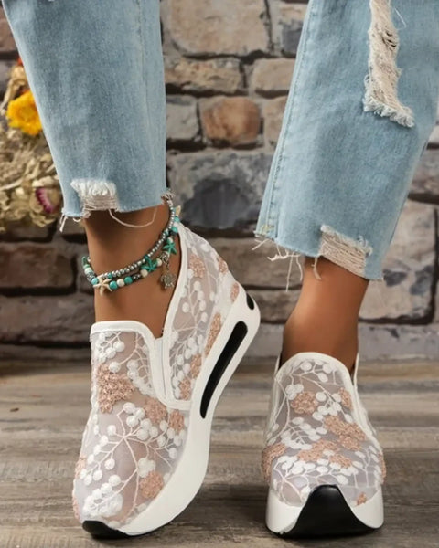 Trendsi slip on platform sneakers with white floral lace design worn with distressed jeans