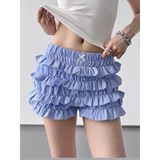 woman wearing Babe Beachwear casual shorts with flouncy Ruffle bottoms for women and teens in blue checkered pattern