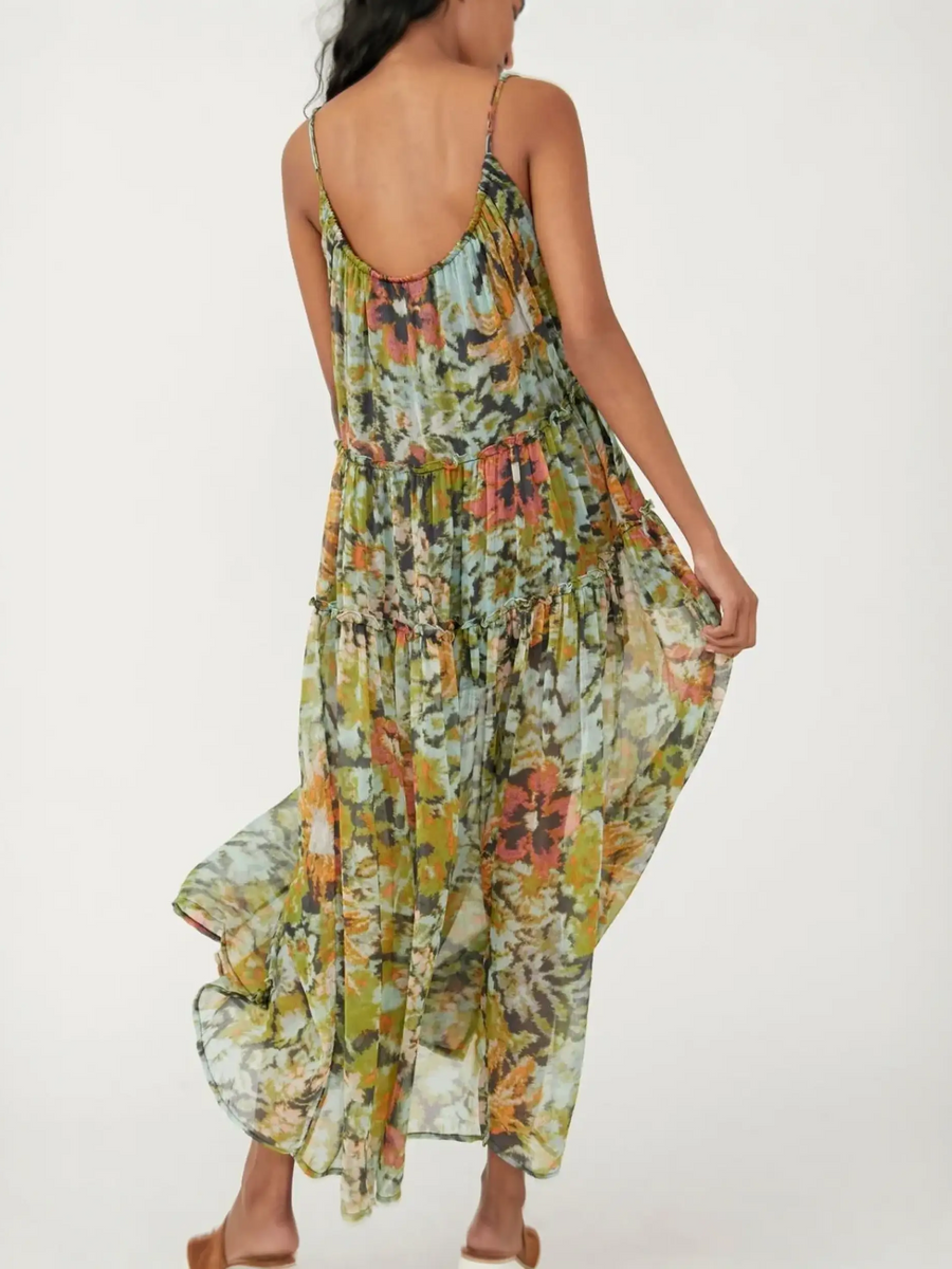 Trendsi flowy maxi dress for beach with floral print and thin straps shown from the back