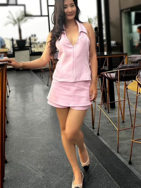 Woman wearing Rag Company nude and silver ballet flats with a pink sleeveless top and skirt