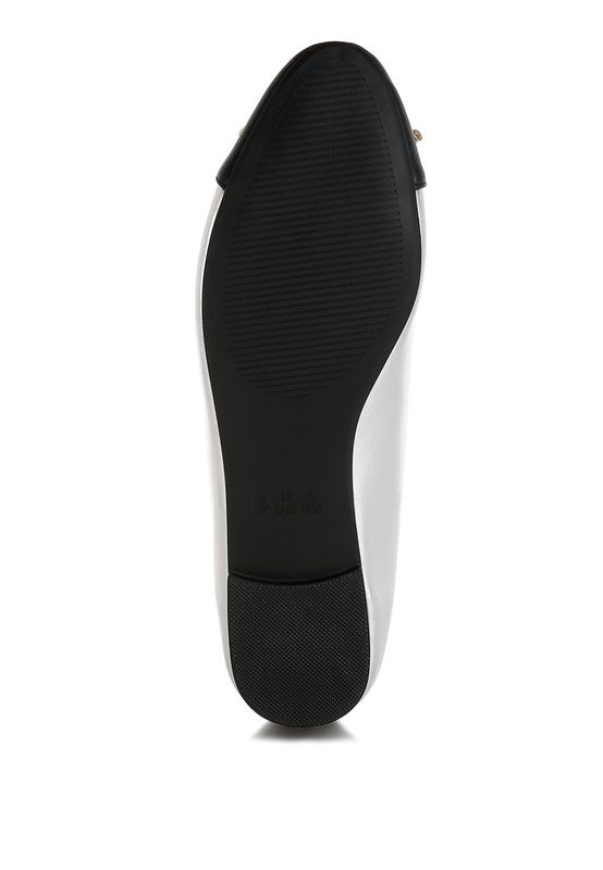 Black sole view of nude and silver ballet flats by Rag Company showing textured grip and heel detail