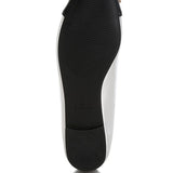 Black sole view of nude and silver ballet flats by Rag Company showing textured grip and heel detail