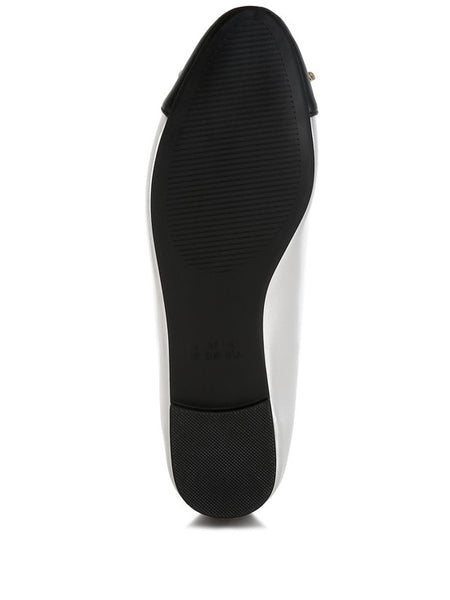 Black sole view of nude and silver ballet flats by Rag Company showing textured grip and heel detail
