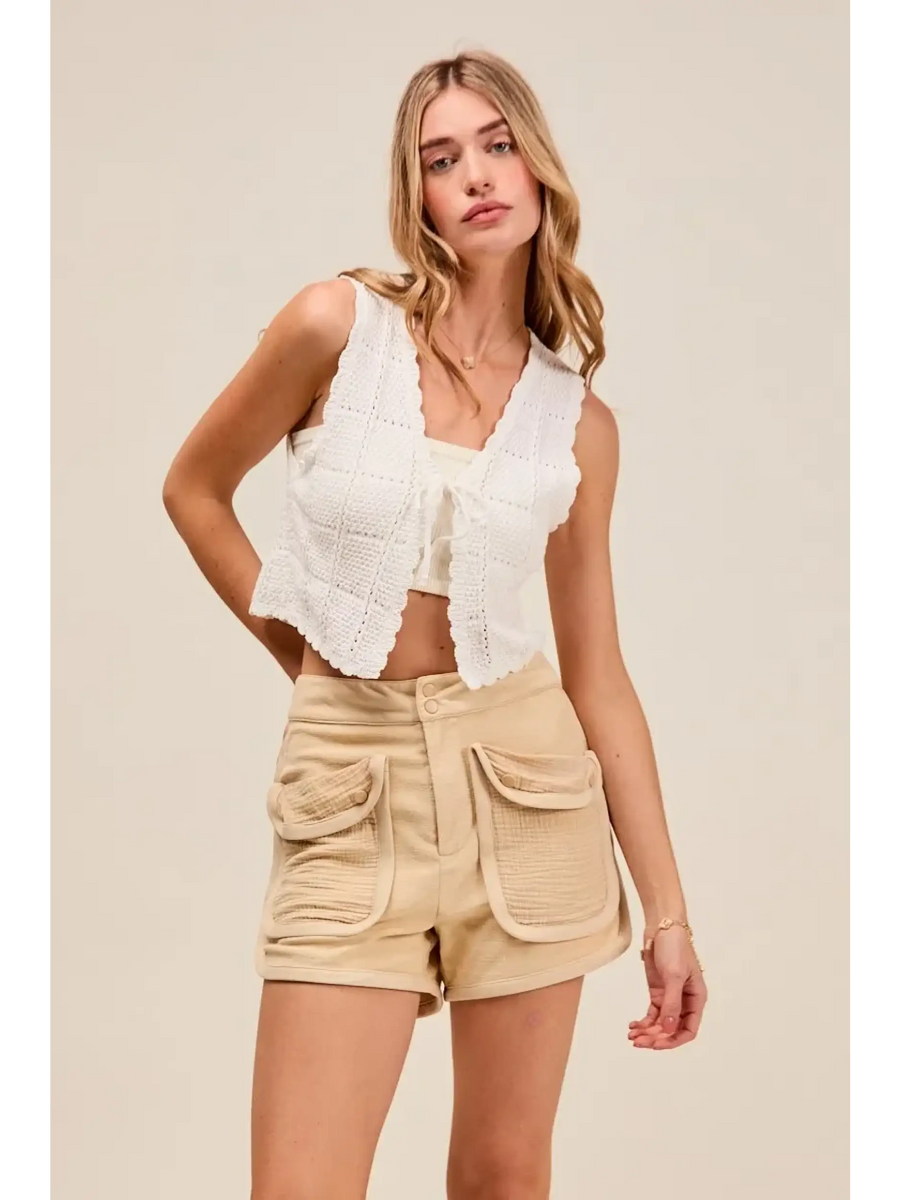 Trendsi beige High Rise Cargo Shorts with large front pockets worn by woman in white sleeveless top