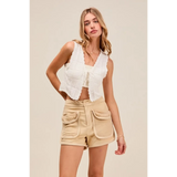 Trendsi beige High Rise Cargo Shorts with large front pockets worn by woman in white sleeveless top