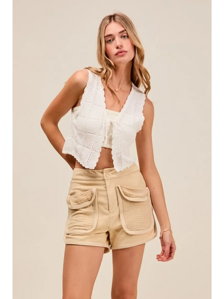 Trendsi beige High Rise Cargo Shorts with large front pockets worn by woman in white sleeveless top