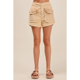 Trendsi beige high rise cargo shorts with large front pockets worn with sandals