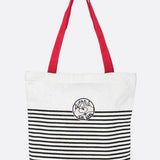 Studio image Babe Beachwear girl gang canvas tote bag with black stripes and red handles