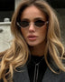 Trendsi glamorous vacation sunglasses with unique geometric black lenses worn by a woman with long blonde hair
