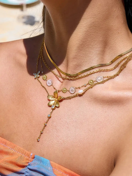 Trendsi 3 piece flower layer chain necklace with gold chains and floral charms on model