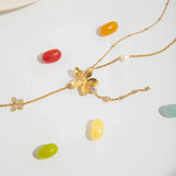 Trendsi 3 piece flower layer chain necklace in gold with pearl and crystal accents on white background
