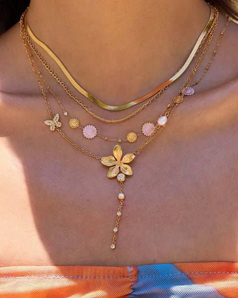 Trendsi 3 piece flower layer chain necklace in gold with flower and butterfly charms on model
