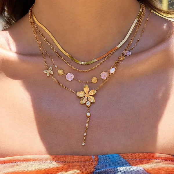 Trendsi 3 piece flower layer chain necklace in gold with flower and butterfly charms on model