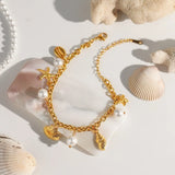 Gold ocean theme bracelet for women with gold shell charms and white pearls
