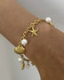 Gold ocean theme bracelet for women with gold chain, starfish charm, seashell charm, and pearls