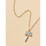 palm tree pendant necklace with sparkling stones and gold chain on beige background