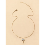 Trendsi gold chain palm tree pendant necklace with rhinestone accents on beige background