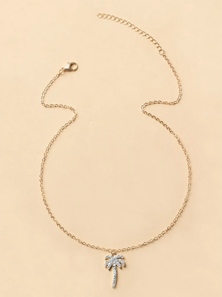Trendsi gold chain palm tree pendant necklace with rhinestone accents on beige background