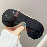 Trendsi gradient aviator sunglasses for women with black lenses and gold frame held in hand