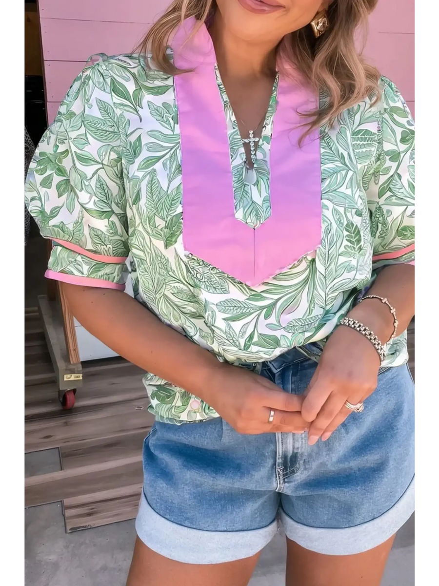 woman wearing green and Pink summer floral blouse for women with puff sleeves and pink collar detail