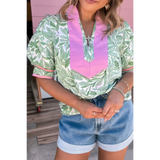 woman wearing green and Pink summer floral blouse for women with puff sleeves and pink collar detail