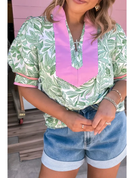 woman wearing green and Pink summer floral blouse for women with puff sleeves and pink collar detail