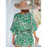 Babe Beachwear blue batwing romper for travel featuring colorful abstract print and relaxed fit