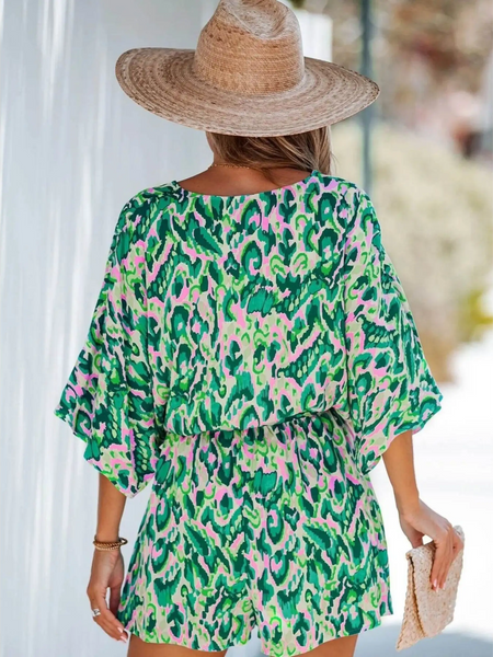 Babe Beachwear blue batwing romper for travel featuring colorful abstract print and relaxed fit