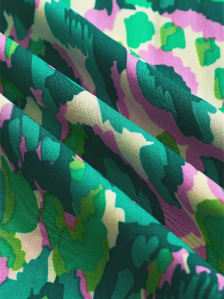 Close-up of colorful fabric pattern for blue batwing romper for travel by Babe Beachwear
