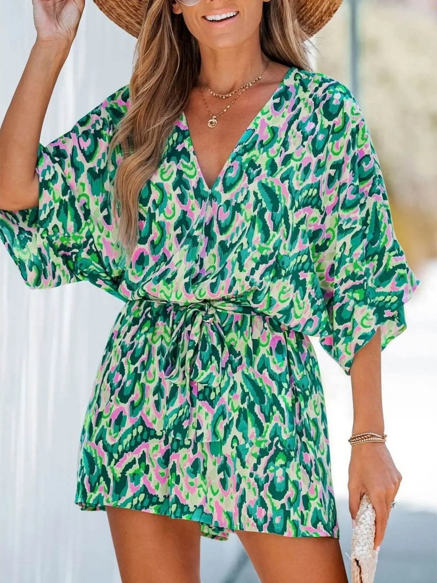 Babe Beachwear blue batwing romper for travel with green and pink abstract print and adjustable waist