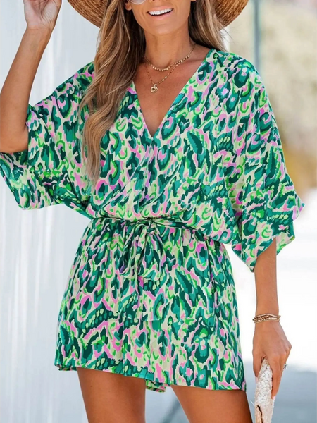 Babe Beachwear blue batwing romper for travel with green and pink abstract print and adjustable waist