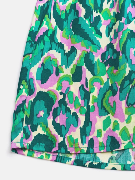Close-up of colorful fabric pattern on Babe Beachwear blue batwing romper for travel