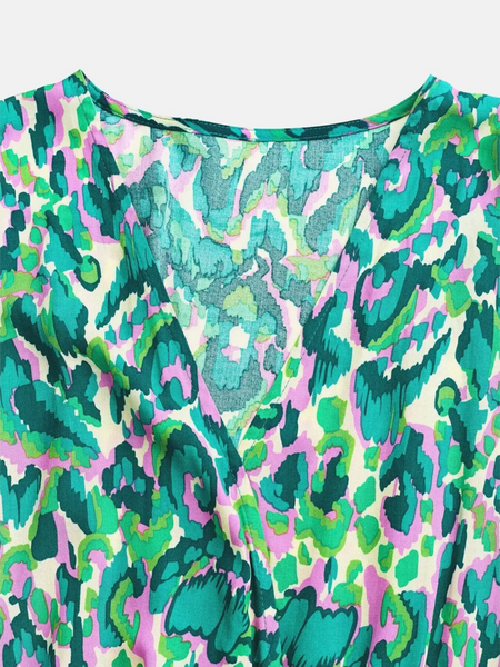 Babe Beachwear blue batwing romper for travel with vibrant green and pink abstract pattern