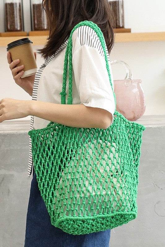 Miss Sparkling green braided net beach tote carried by woman with coffee cup and casual outfit