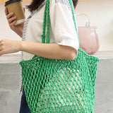 Miss Sparkling green braided net beach tote carried by woman with coffee cup and casual outfit
