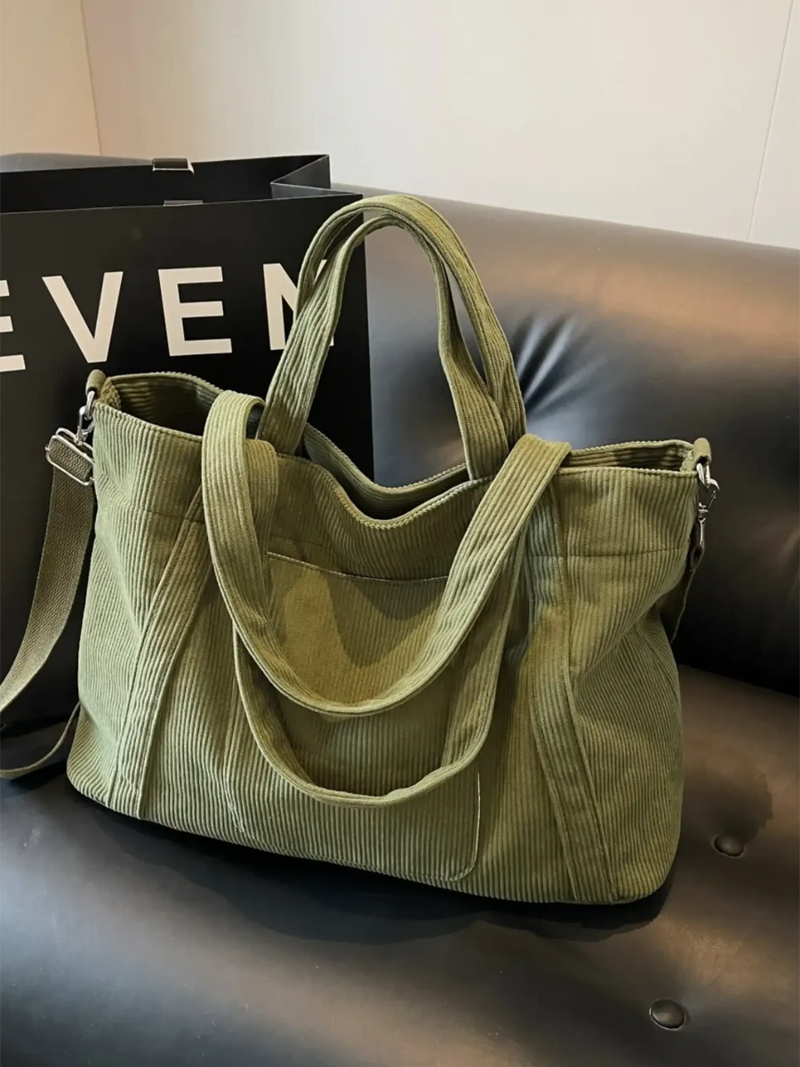 Babe Beachwaer lightweight Ladies duffle bag in olive green corduroy fabric on black leather couch