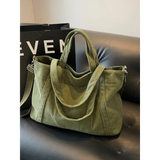 Babe Beachwaer lightweight Ladies duffle bag in olive green corduroy fabric on black leather couch