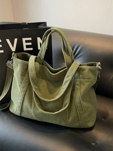 Babe Beachwaer lightweight Ladies duffle bag in olive green corduroy fabric on black leather couch
