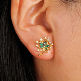 Green Palm Leaves Stud Earrings on ear with gold and green gemstone design