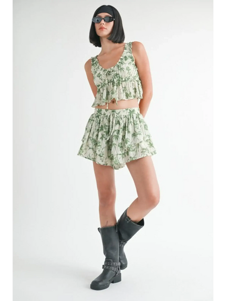 Emory Park green tropical flutter shorts with matching sleeveless top worn with black boots and sunglasses