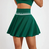 Green tennis skirt by Trendsi featuring a wide waistband and pleated design for women's athletic skort summer