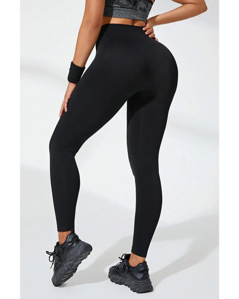 Babe Beachwear black high waisted leggings worn by model with black athletic shoes and wristband
